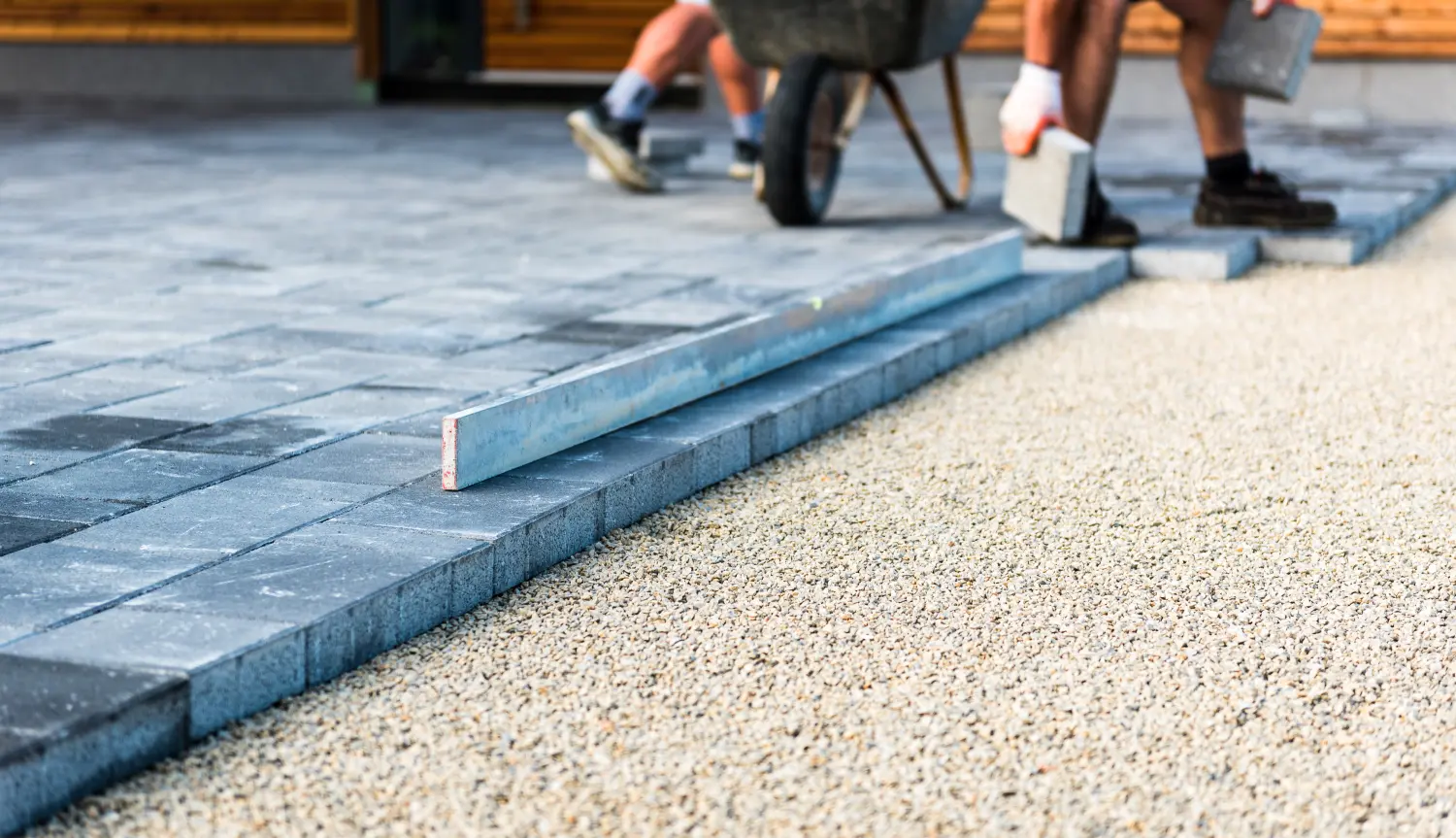 Verlegung von grauen Betonplatten in Haus, Hof, Einfahrt und Terrasse.